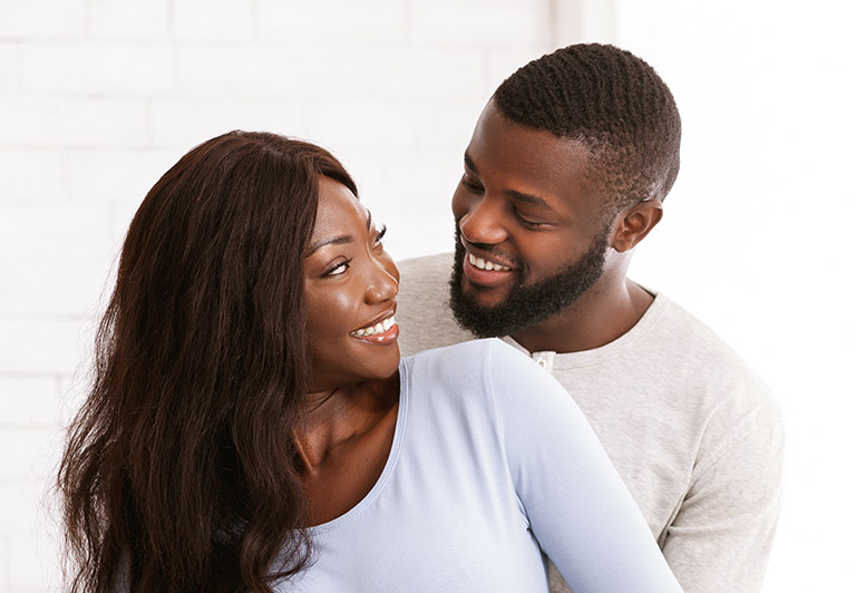 black woman and black man smiling at each other